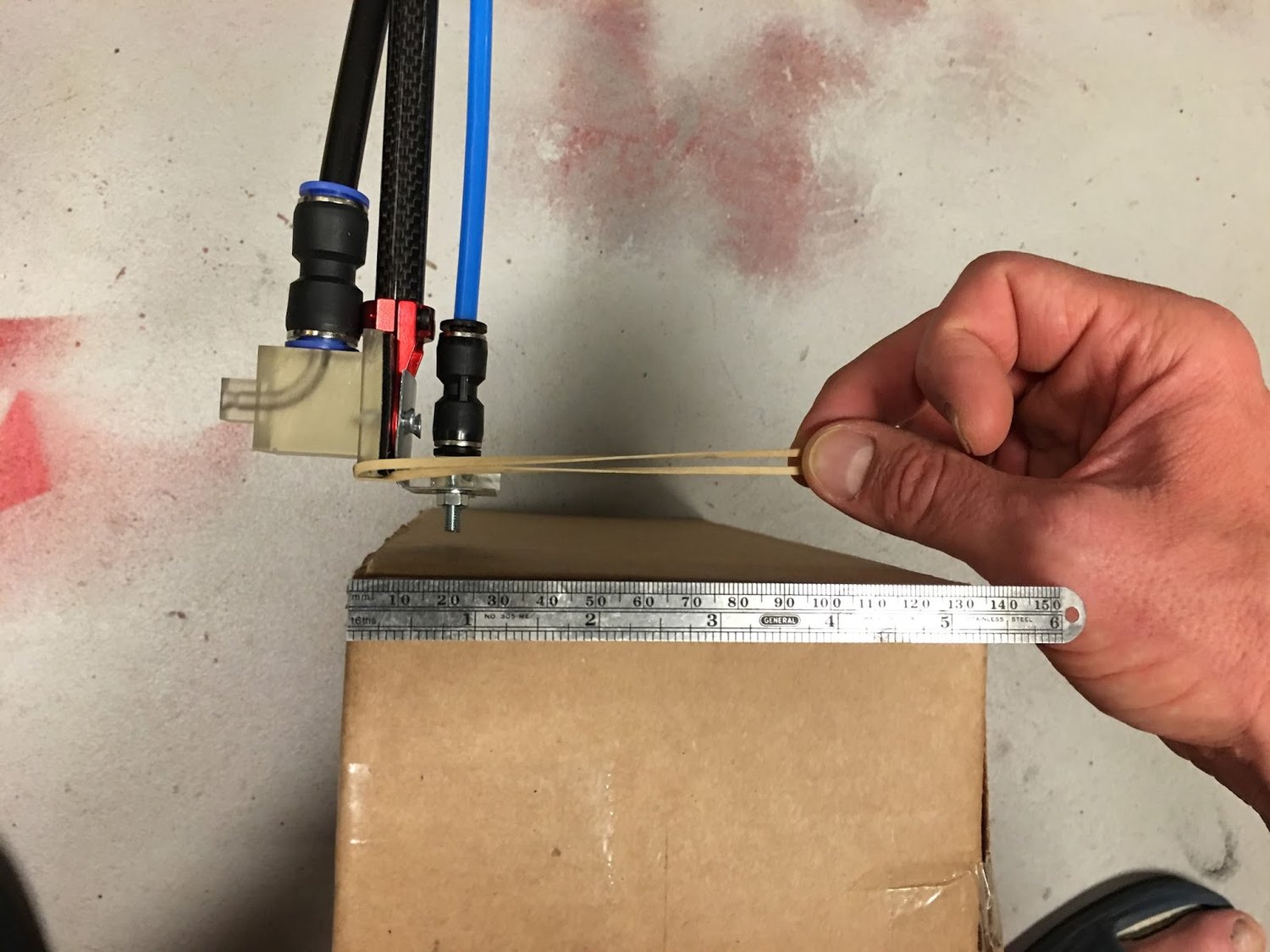 The HAPP project utilizes only the most sophisticated technologies: Cardboard box, millimeter scale, and an old rubber band. Nozzle v6 points left and v3 points right.
