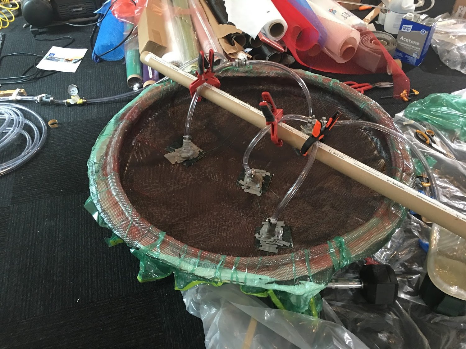 Resin feed tubes clamped in place